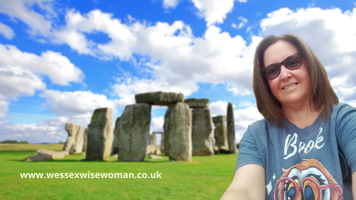 Kim Brockway up at Stonehenge with beautiful sky and a cloud shaped like a crocodile.