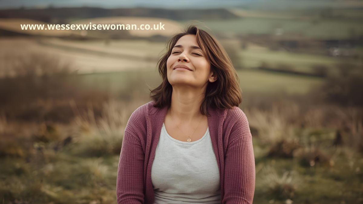 Midlife woman breathing calmly outdoors in Wiltshire meadow