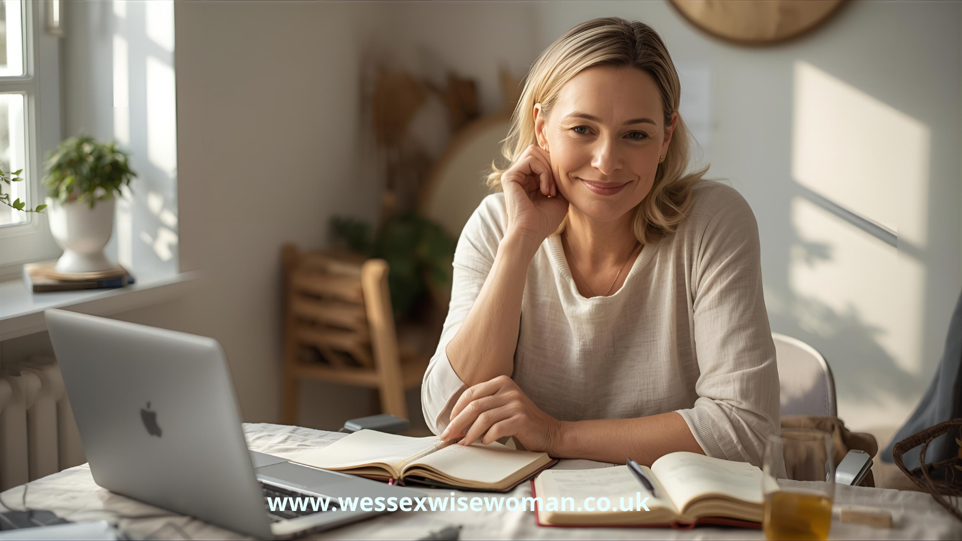 Awaken Your Inner Magic (woman 40s 50s with shoulder-length blonde-brown hair wearing casual beige top sat at home desk smiling)